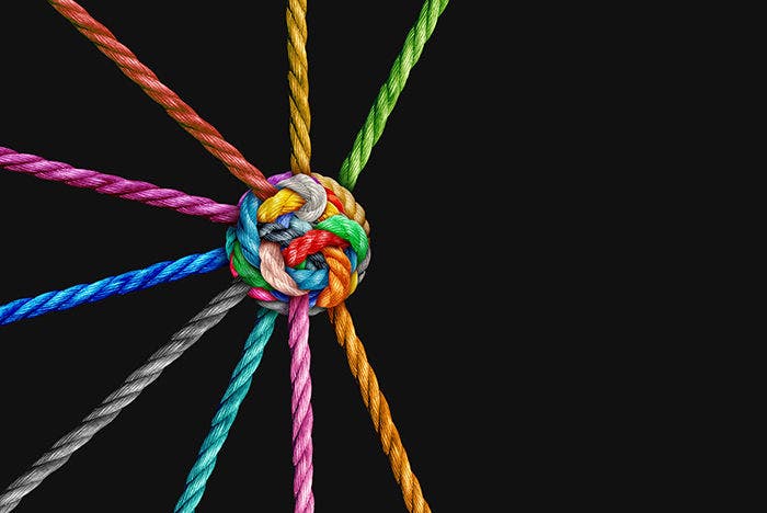 Integrated Collaboration or Collective Effort Integration and Unity with teamwork concept as a business metaphor for joining a partnership synergy and cohesion as diverse ropes connected together.
