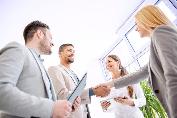 Business Agreement.Image of four successful business partners working at meeting in office.