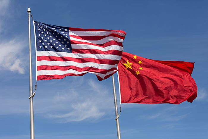 American Chinese windy day flags fly together on flagpole. Symbolic of Sino-American relations, the flag of the United States of America and the flag of the Republic of China fly together on flag poles next to each other on a sunny, windy day.